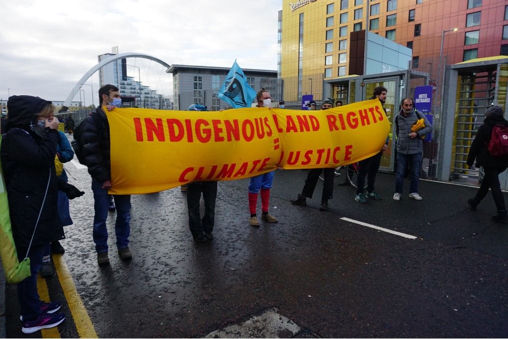 Indigenous Land Rights equals Climate Justice banner at COP26