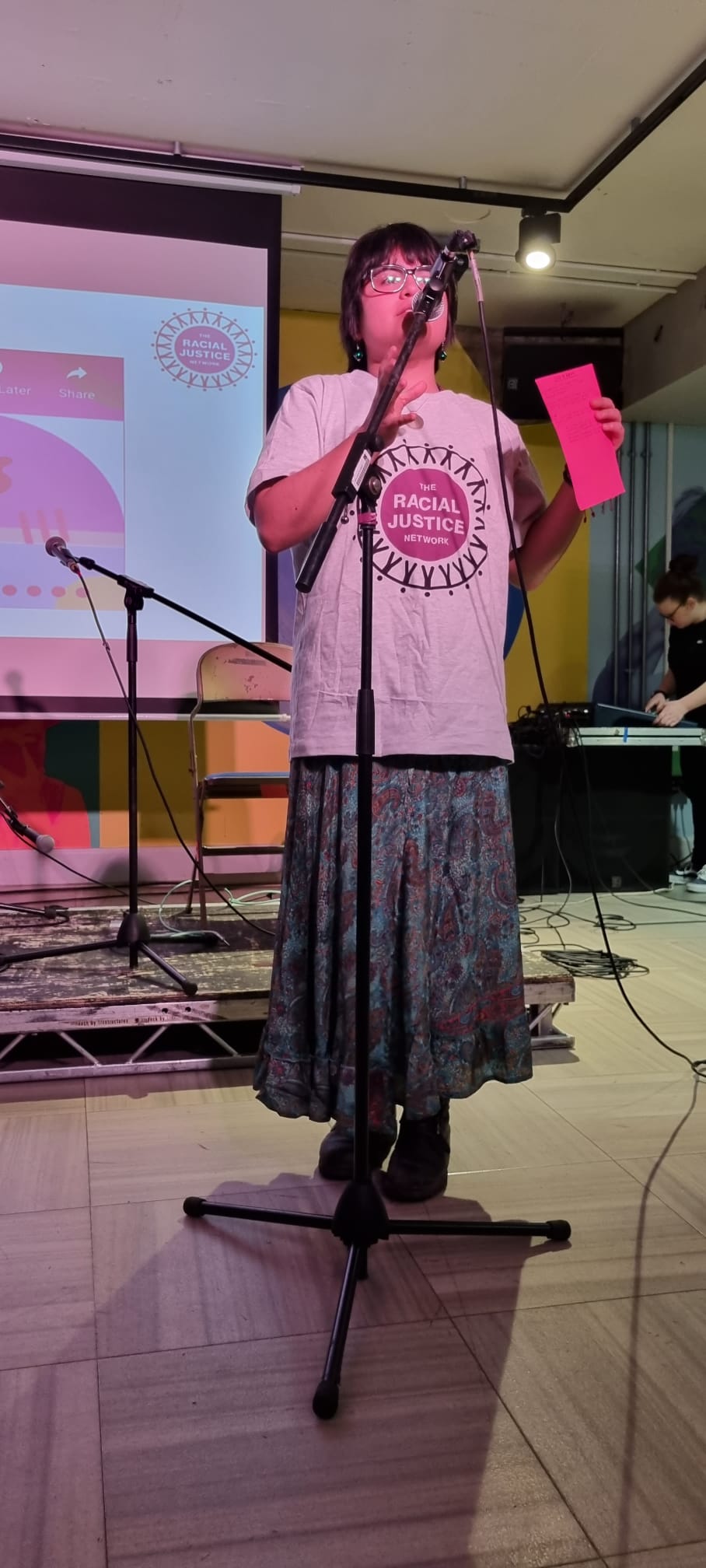 Speaker in RJN t-shirt on stage