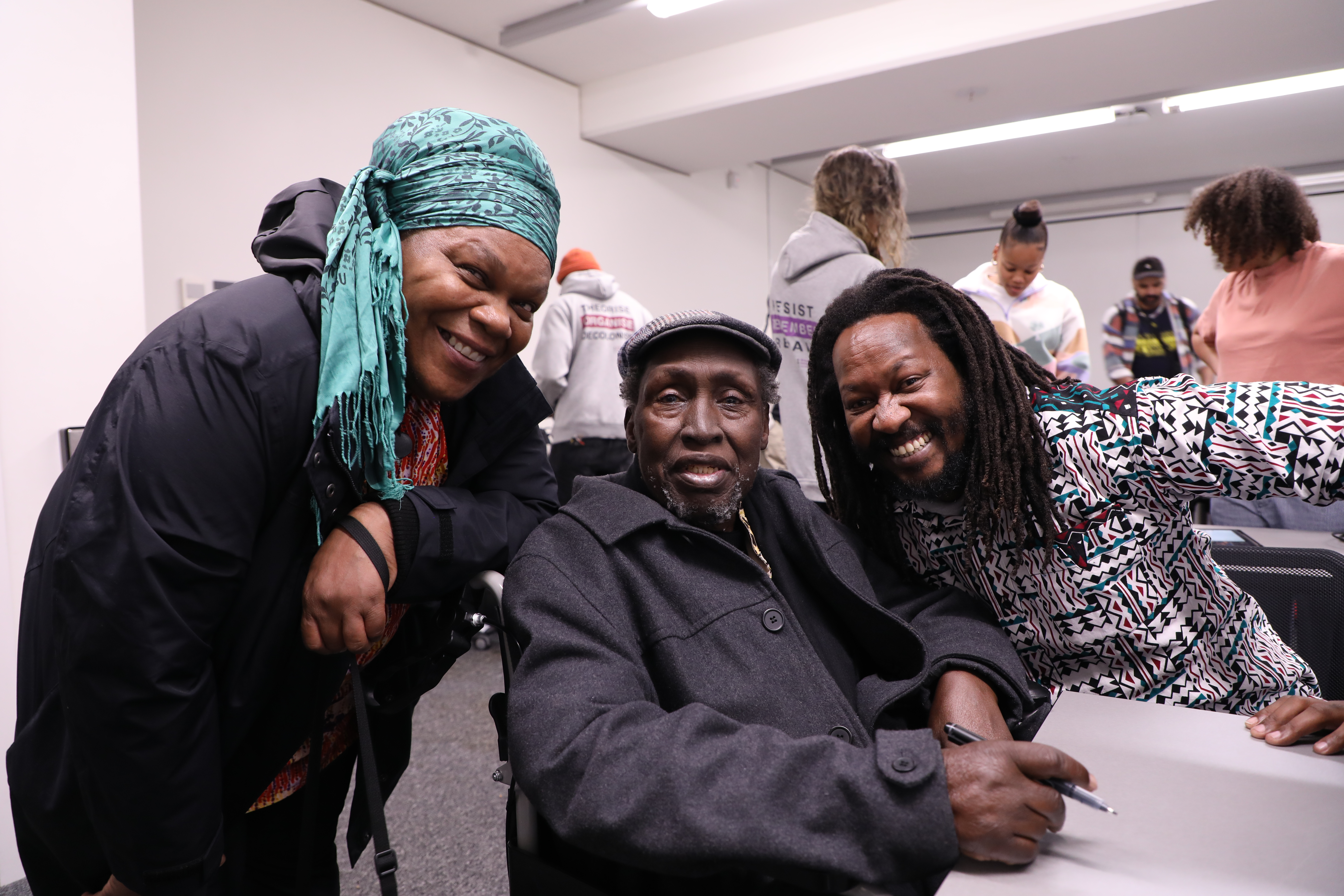 Professor Ngũgĩ wa Thiong'o signing books with RJN members